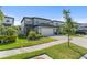 Two-story house exterior with gray siding and landscaping at 9358 Rally Spring Loop, Wesley Chapel, FL 33545