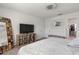 Bedroom with large TV, walk-in closet, and ensuite at 9358 Rally Spring Loop, Wesley Chapel, FL 33545