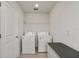 Bright laundry room with washer, dryer, and shelving at 9358 Rally Spring Loop, Wesley Chapel, FL 33545