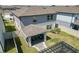 Two-story home with covered patio, fire pit, and fenced backyard at 9358 Rally Spring Loop, Wesley Chapel, FL 33545