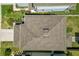 Aerial view of a house with a brown asphalt shingle roof at 9358 Rally Spring Loop, Wesley Chapel, FL 33545