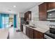 Kitchen with stainless steel appliances and access to backyard at 9358 Rally Spring Loop, Wesley Chapel, FL 33545