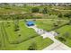 Aerial view of a fenced dog park with benches and waste disposal stations at 9358 Rally Spring Loop, Wesley Chapel, FL 33545