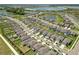 Aerial view of a residential community with houses, lakes, and lush green areas at 9358 Rally Spring Loop, Wesley Chapel, FL 33545