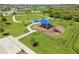 Aerial view of a playground with slides and swings in a residential community at 9358 Rally Spring Loop, Wesley Chapel, FL 33545