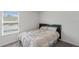Cozy bedroom with window and neutral decor at 9358 Rally Spring Loop, Wesley Chapel, FL 33545
