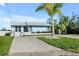 Light blue house with palm trees and a long driveway at 821 White Heron Blvd, Ruskin, FL 33570