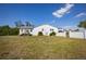 Back of house, showcasing a large yard and canal views at 821 White Heron Blvd, Ruskin, FL 33570