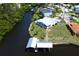 Aerial view of waterfront home with private dock and lush landscaping at 821 White Heron Blvd, Ruskin, FL 33570