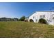 Side view of house showing large yard and canal views at 821 White Heron Blvd, Ruskin, FL 33570