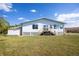Back of house, featuring a large yard, wooden deck and detached shed at 821 White Heron Blvd, Ruskin, FL 33570