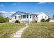 Back of house with stone path and green lawn at 821 White Heron Blvd, Ruskin, FL 33570