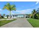 Light blue house with palm trees and a long driveway at 821 White Heron Blvd, Ruskin, FL 33570