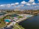 Community aerial view showcasing pools, lawn games, lake, clubhouse, tennis courts, and well manicured landscaping at 140 Riviera Dunes Way # 1403, Palmetto, FL 34221