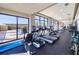 Well-equipped fitness center with treadmills and exercise bikes overlooking the pool and lush landscape at 140 Riviera Dunes Way # 1403, Palmetto, FL 34221