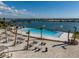 Relaxing pool with lounge chairs and sandy beach area, perfect for enjoying sunny days and waterfront views at 140 Riviera Dunes Way # 1403, Palmetto, FL 34221