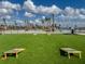 Enjoy outdoor games with a cornhole area adjacent to the pool under sunny skies at 140 Riviera Dunes Way # 1403, Palmetto, FL 34221