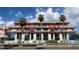 Modern luxury townhomes with large windows and a stylish architectural design, complemented by palm trees at 85 Davis Blvd # A, Tampa, FL 33606