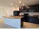 Modern kitchen with granite countertops, black appliances, and an island at 6949 Crested Orchid Dr, Brooksville, FL 34602