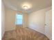 Simple bedroom with carpeted floor and large window at 6949 Crested Orchid Dr, Brooksville, FL 34602
