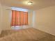 Bedroom with carpeted floors and peach curtains at 6949 Crested Orchid Dr, Brooksville, FL 34602
