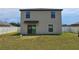 Two-story house with backyard, sliding glass door, and fenced yard at 6949 Crested Orchid Dr, Brooksville, FL 34602