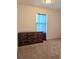 Bedroom with carpeted floors and a dresser at 6949 Crested Orchid Dr, Brooksville, FL 34602