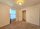 Well-lit bedroom with neutral walls and carpeted floors at 6949 Crested Orchid Dr, Brooksville, FL 34602
