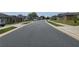 Quiet residential street with houses and parked cars at 6949 Crested Orchid Dr, Brooksville, FL 34602