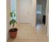 Bright entryway with tile flooring, a plant, and a view of a half-bathroom at 6949 Crested Orchid Dr, Brooksville, FL 34602