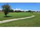 Expansive green golf course with a winding cart path at 6949 Crested Orchid Dr, Brooksville, FL 34602