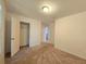 Well-lit bedroom with carpeted floors and an adjacent bathroom at 6949 Crested Orchid Dr, Brooksville, FL 34602