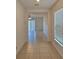 Tile entryway with a view into a living area and plenty of natural light at 6949 Crested Orchid Dr, Brooksville, FL 34602