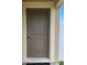 Brown front door with a simple design and a doormat at 6949 Crested Orchid Dr, Brooksville, FL 34602