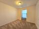 Bright bedroom featuring carpeted floors and a closet at 6949 Crested Orchid Dr, Brooksville, FL 34602