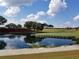 Serene golf course with a pond reflecting the sky at 6949 Crested Orchid Dr, Brooksville, FL 34602