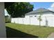 Backyard with white privacy fence and small trees at 3917 W Robson St, Tampa, FL 33614