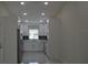 Modern kitchen with white cabinets, stainless steel appliances, and quartz countertops at 3917 W Robson St, Tampa, FL 33614