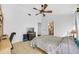 Bedroom featuring a ceiling fan, neutral tile flooring, and a door to the bathroom at 1442 Tiverton Dr, Brandon, FL 33511