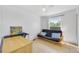 Spare bedroom featuring light tile floors, futon, and a bright window at 1442 Tiverton Dr, Brandon, FL 33511