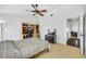 Bright bedroom featuring a ceiling fan, built-in desk, and neutral tile flooring at 1442 Tiverton Dr, Brandon, FL 33511