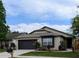 Beautiful home with a well-manicured lawn, two-car garage, and attractive landscaping at 1442 Tiverton Dr, Brandon, FL 33511