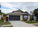 Charming single-story home featuring a two-car garage, well-maintained landscaping, and a welcoming entrance at 1442 Tiverton Dr, Brandon, FL 33511