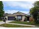 Beautiful home with landscaped front yard, featuring a charming exterior and well-manicured lawn at 1442 Tiverton Dr, Brandon, FL 33511