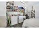 Laundry room with shelving, washer and dryer, utility sink, and car access at 1442 Tiverton Dr, Brandon, FL 33511