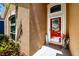 Red front door with welcome decor and landscaping at 7532 Regents Garden Way, Apollo Beach, FL 33572