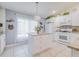 Modern kitchen with white cabinets, granite island, and stainless steel appliances at 7532 Regents Garden Way, Apollo Beach, FL 33572