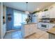 Bright kitchen with white cabinets, granite countertops, and an island at 7532 Regents Garden Way, Apollo Beach, FL 33572