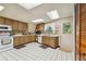 Efficient kitchen featuring wood cabinets, tile floors, and a window at 2512 Ayers Hill Ct, Lutz, FL 33559