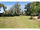 Large grassy backyard with mature trees at 2512 Ayers Hill Ct, Lutz, FL 33559